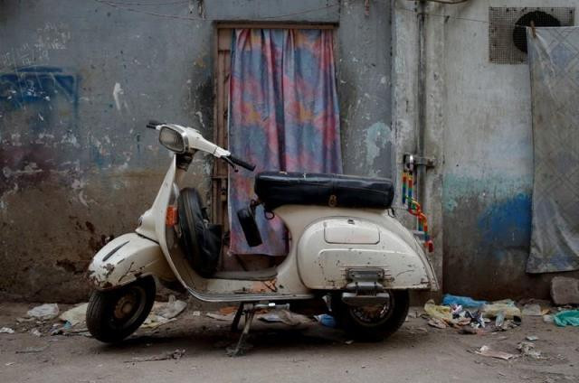 a vespa scooter stands near a workshop where old vespa parts are painted on a street in karachi pakistan february 28 2018 photo reuters a vespa scooter stands near a workshop where old vespa parts are painted on a street in karachi pakistan february 28 2018 photo reuters