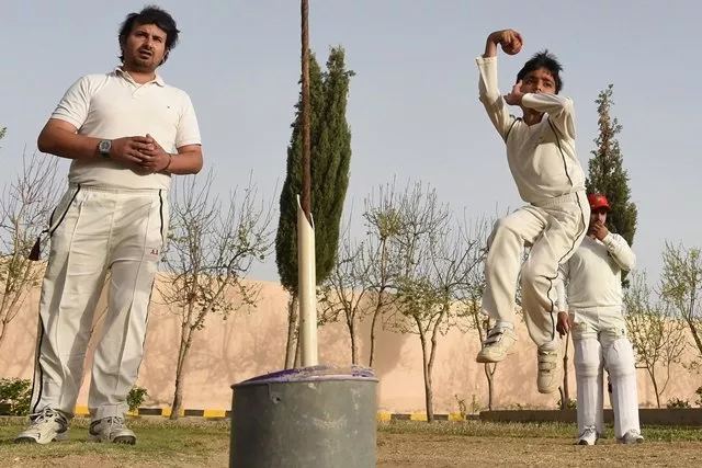 pakistani child eli mikal khan 6 delivers a ball as his father abdullah khan l who is a local cricket coach and runs an academy watches during a cricket bowling practice in quetta photo afp pakistani child eli mikal khan 6 delivers a ball as his father abdullah khan l who is a local cricket coach and runs an academy watches during a cricket bowling practice in quetta photo afp