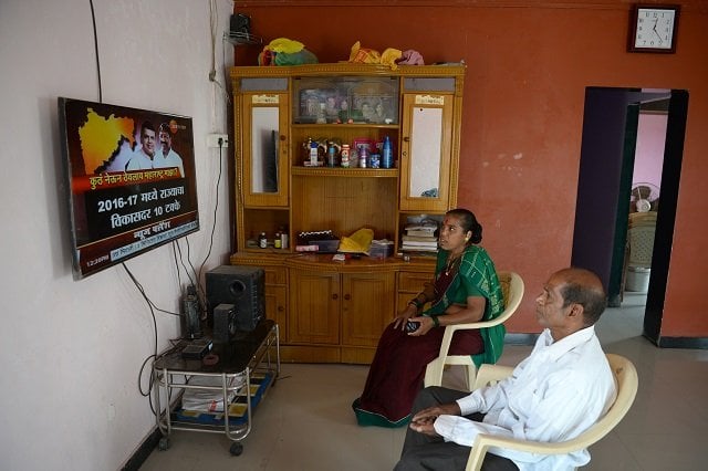 this photo taken on march 9 2018 shows a couple watching television in their house on elephanta island near mumbai on march 9 2018 hundreds of villagers on the unesco heritage listed island of elephanta have had mains electricity installed in their houses for the first time local officials hope tourists who take a short boat ride from the bustle of mumbai to visit the island 039 s famed fifth century caves will now spend more time and money there boosting local businesses and jobs photo afp