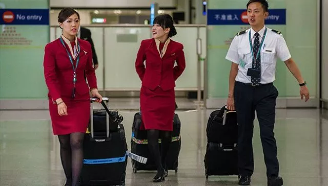 the airline said it would re evaluate the uniforms for cathay pacific and cathy dragon photo afp the airline said it would re evaluate the uniforms for cathay pacific and cathy dragon photo afp