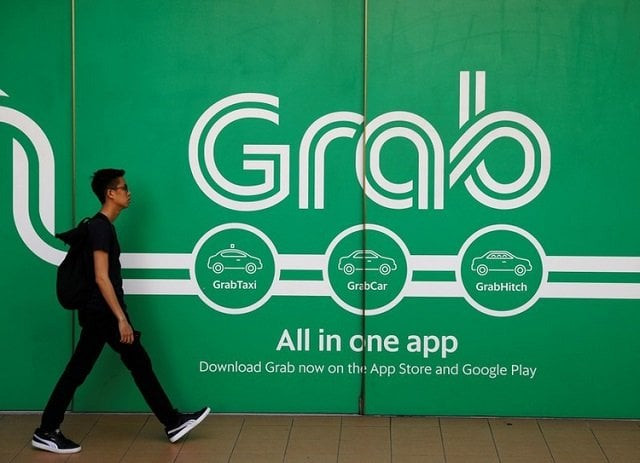a man walks past a grab office in singapore march 26 2018 photo reuters a man walks past a grab office in singapore march 26 2018 photo reuters