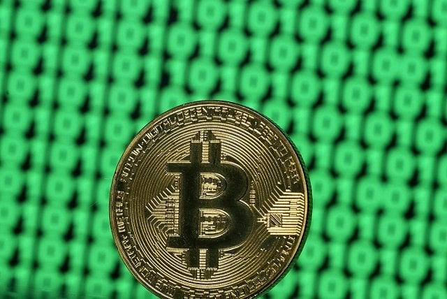 a token of the virtual currency bitcoin is seen placed on a monitor that displays binary digits in this illustration picture december 8 2017 photo reuters a token of the virtual currency bitcoin is seen placed on a monitor that displays binary digits in this illustration picture december 8 2017 photo reuters
