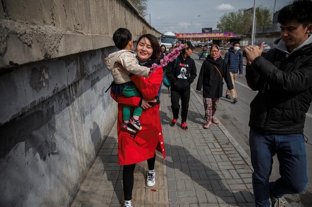 li wenzu wife of detained chinese rights lawyer wang quanzhang is followed by reporters and friends as she walks away from a supreme people 039 s court complaints office in beijing china april 4 2018 photo reuters