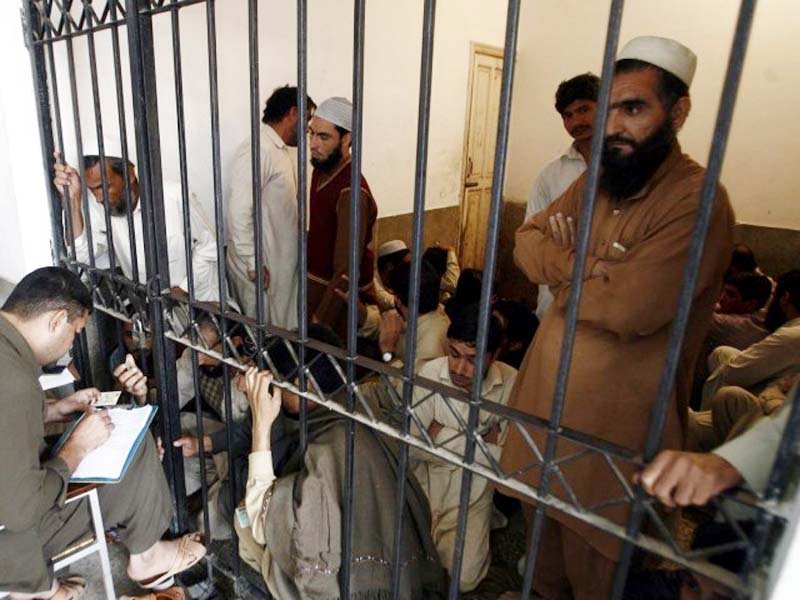 a jail official takes details of prisoners photo file