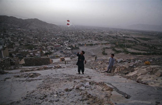 a boy from the hazara community flies a kite on a hilltop overlooking houses in mehrabad quetta on august 29 2012 photo reuters a boy from the hazara community flies a kite on a hilltop overlooking houses in mehrabad quetta on august 29 2012 photo reuters