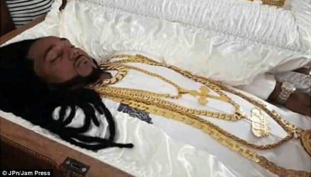 man wears 100 000 worth of jewellery lies in gold casket during last rites