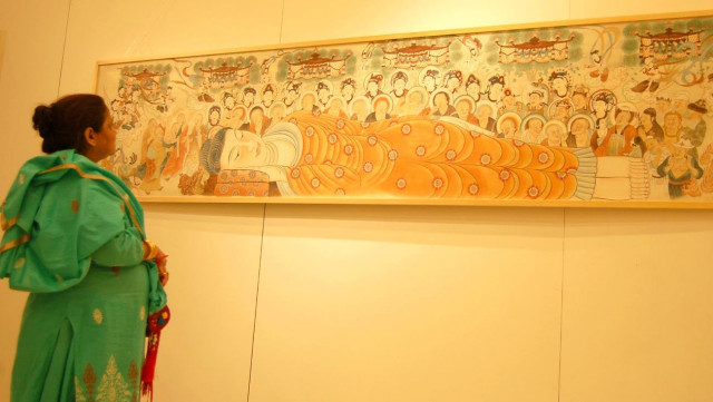 a mural depicting traditional chinese designs displayed at a cultural show at the pakistan china friendship centre top an artist hand paints masks at the commemorative event highlighting chinese art on tuesday photos muhammad javaid a mural depicting traditional chinese designs displayed at a cultural show at the pakistan china friendship centre top an artist hand paints masks at the commemorative event highlighting chinese art on tuesday photos muhammad javaid