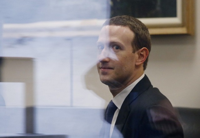 facebook ceo mark zuckerberg is seen through reflective glass as he sits in the office of senator bill nelson d fl while he waits for a meeting in the hart senate office building in washington us april 9 2018 photo reuters