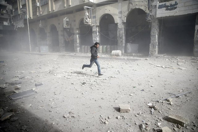 a man is seen running after an air raid in the besieged town of douma in eastern ghouta in damascus syria february 6 2018 photo reuters a man is seen running after an air raid in the besieged town of douma in eastern ghouta in damascus syria february 6 2018 photo reuters