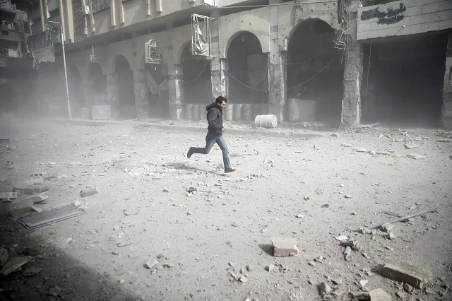 a man is seen running after an air raid in the besieged town of douma in eastern ghouta in damascus syria february 6 2018 photo reuters a man is seen running after an air raid in the besieged town of douma in eastern ghouta in damascus syria february 6 2018 photo reuters