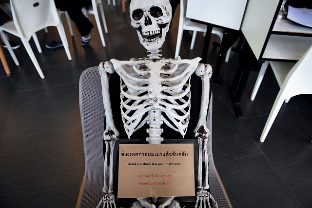 this photo taken on april 5 2018 shows a skeleton on a chair at the kid mai death awareness cafe an exhibition space built to educate the public about death and buddhism in bangkok with drinks called quot death quot and quot painful quot on the menu and a skeleton splayed out on a couch in the corner the meet your maker theme is alive and well at this open air lunch spot in the thai capital photo afp