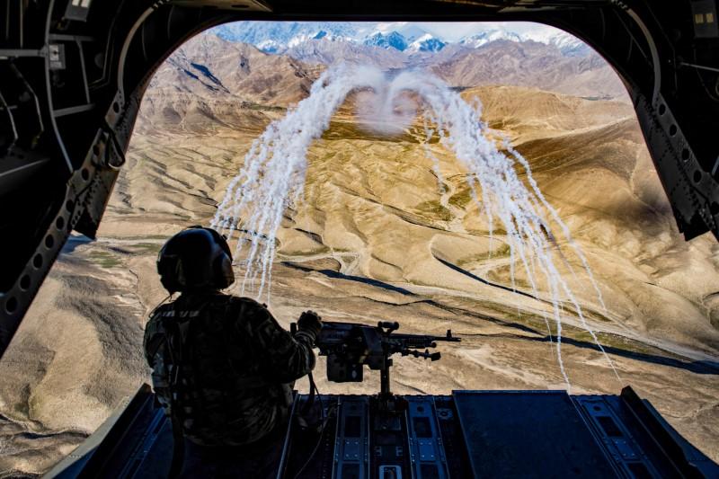 a us army crew chief flying on board a ch 47f chinook helicopter observes the successful test of flares during a training flight in afghanistan photo reuters