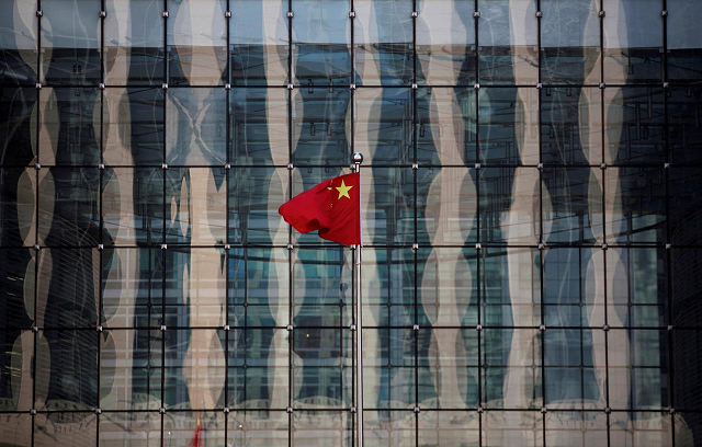 a chinese national flag flutters at the headquarters of a commercial bank on a financial street in central beijing china november 24 2014 photo reuters