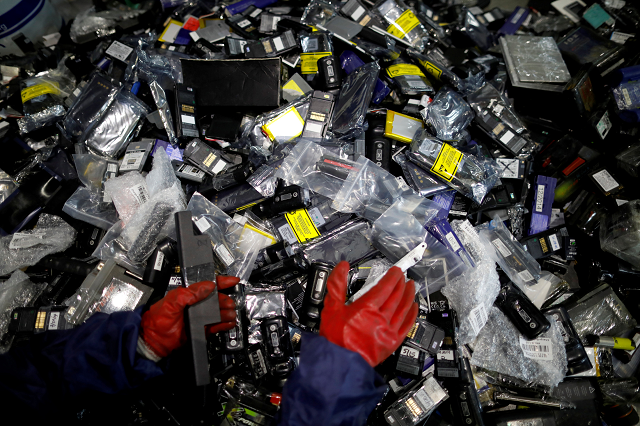 an employee sorts out old batteries at an urban mining plant in gunsan april 2 2018 photo reuters