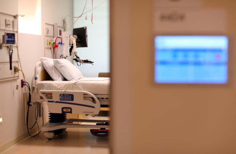 an electronic patients chart is shown on the wall to a hospital room photo reuters