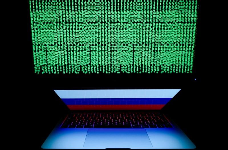 a russian flag is seen on the laptop screen in front of a computer screen on which cyber code is displayed in this illustration picture taken march 2 2018 photo reuters