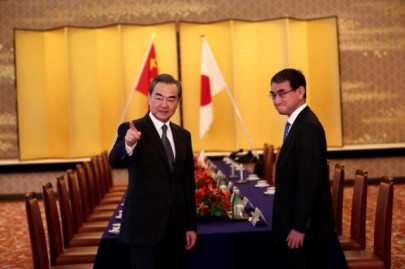 japan and china s foreign ministers pledge to pursue improved ties