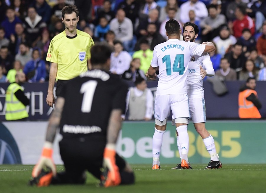 real madrid 039 s spanish midfielder isco r congratulates real madrid 039 s brazilian midfielder casemiro for his goal during the spanish league footbal match between malaga cf and real madrid cf at la rosaleda stadium in malaga on april 15 2018 photo afp