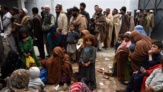 afghan refugees gather for renewal of their family cards at the chamkany registration center on the outskirts of peshawar photo afp