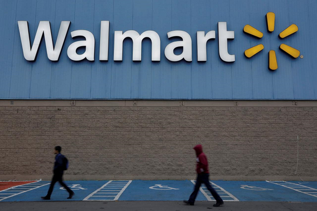 men walk past the logo of walmart outside a store in monterrey mexico february 12 2018 photo reuters