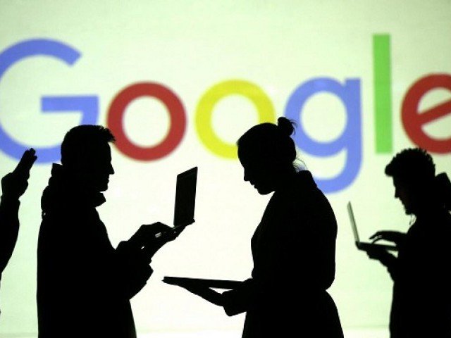 silhouettes of laptop and mobile device users are seen next to a screen projection of google logo in this picture illustration taken march 28 2018 photo reuters