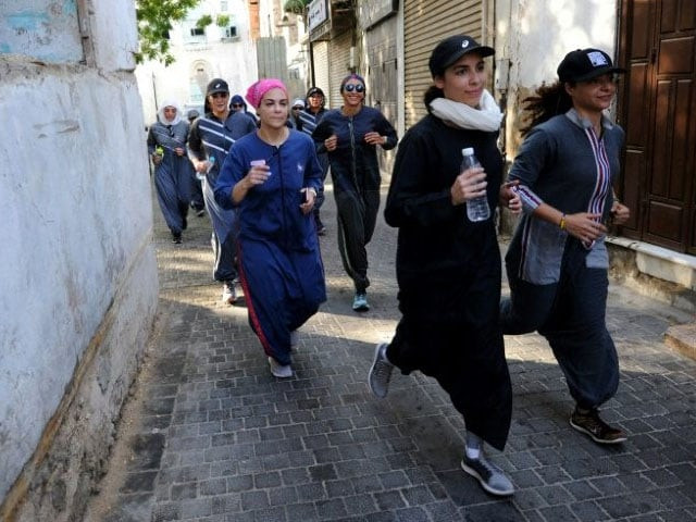 sports abayas still envelop the female form but offer greater movement than the classic baggy version whose flowing hemline would be a handicap photo file sports abayas still envelop the female form but offer greater movement than the classic baggy version whose flowing hemline would be a handicap photo file