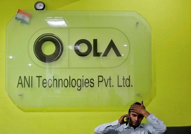 an employee speaks over his phone as he sits at the front desk inside the office of ola cab service in gurugram previously known as gurgaon on the outskirts of new delhi india april 20 2016 photo reuters