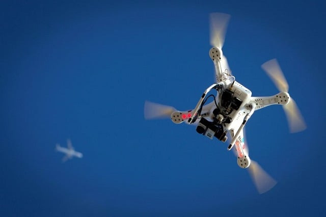 an airplane flies over a drone during the polar bear plunge on coney island in the brooklyn borough of new york us january 1 2015 photo reuters an airplane flies over a drone during the polar bear plunge on coney island in the brooklyn borough of new york us january 1 2015 photo reuters