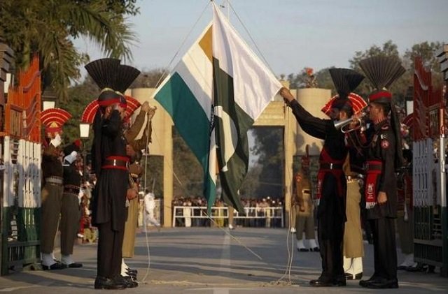 pakistan rangers r and indian border security force personnel take part in the daily flag lowering ceremony at their joint border post of wagah near lahore photo reuters