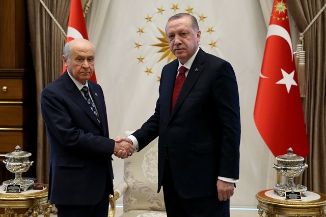 a handout picture taken and released by the turkish presidential press service on april 18 2018 shows turkish president recep tayyip erdogan r shaking hands with devlet bahceli l leader of the turkish far right and ultranationalism party called turkish national movement party mhp during their meeting at the presidential complex in ankara photo afp
