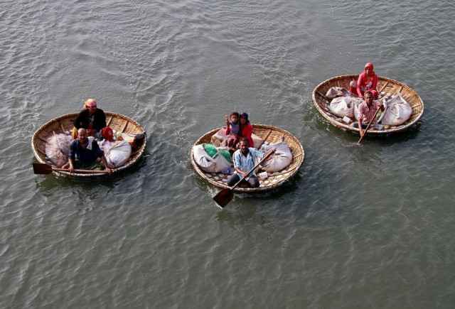 fishermen paddle their boats as they carry their family members in the waters of vembanad lake in kochi india photo reuters fishermen paddle their boats as they carry their family members in the waters of vembanad lake in kochi india photo reuters