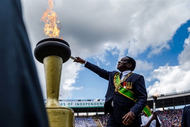 zimbabwe 039 s president emmerson mnangagwa lights the eternal flame of freedom during zimbabwe independence day celebrations at the national sports stadium on april 18 2018 in harare photo afp