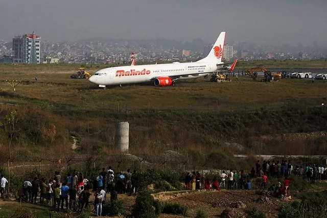 people gather near an aircraft belonging to malindo air that skidded off the runway during take off last night at tribhuvan international airport in kathmandu nepal april 20 2018 photo reuters people gather near an aircraft belonging to malindo air that skidded off the runway during take off last night at tribhuvan international airport in kathmandu nepal april 20 2018 photo reuters