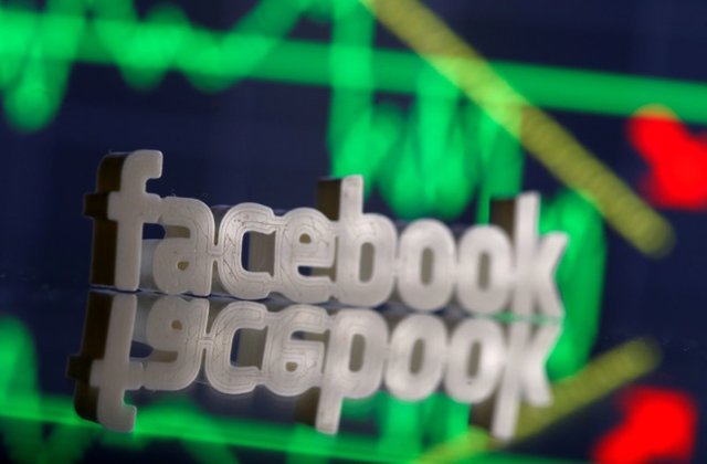 a 3d printed facebook logo is seen in front of displayed stock graph in this illustration photo march 20 2018 photo reuters