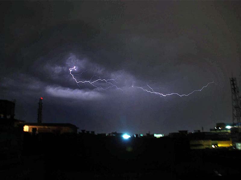 lightning strikes in peshawar while a woman treads through snow in chitral photo agencies