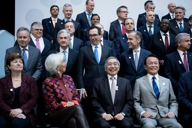 imf managing director christine lagarde who warned about rising protectionism looks to us treasury secretary steven mnuchin during a group photo of g 20 finance ministers and central bank governors photo afp imf managing director christine lagarde who warned about rising protectionism looks to us treasury secretary steven mnuchin during a group photo of g 20 finance ministers and central bank governors photo afp