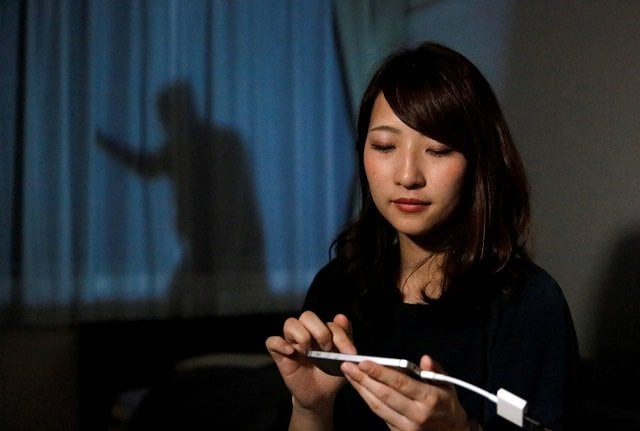 leopalace 21 employee mai shibata poses with her mobile phone during a demonstration of the company 039 s security system 039 man on the curtain 039 in her room in tokyo japan april 20 2018 photo reuters