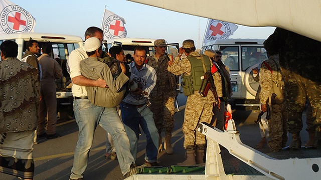 red cross medics carry a wounded man to a plane during an evacuation of injured people from dammaj in yemen 039 s northwestern province of saana photo reuters file