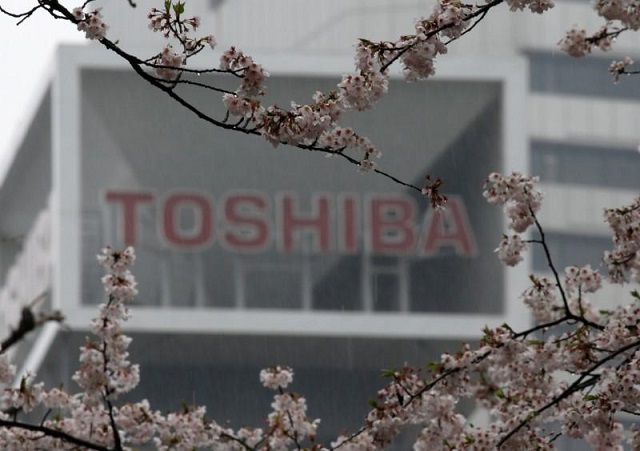 the logo of toshiba is seen behind cherry blossoms at the company 039 s headquarters in tokyo japan april 11 2017 photo reuters