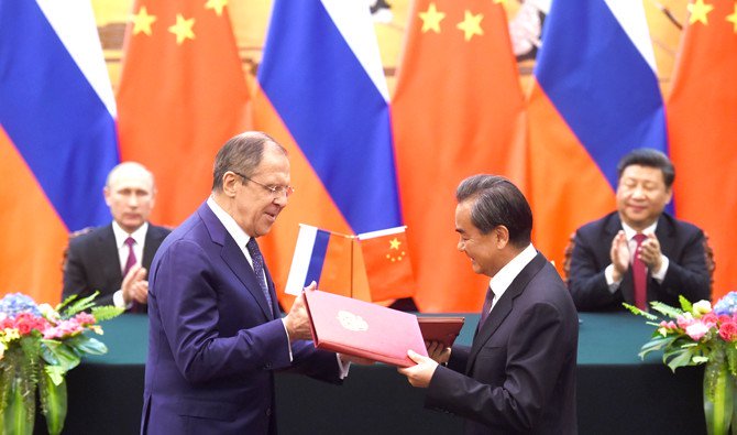 russian foreign minister sergey lavrov and chinese foreign minister wang yi exchange documents in beijing 039 s great hall of the people in 2016 photo afp