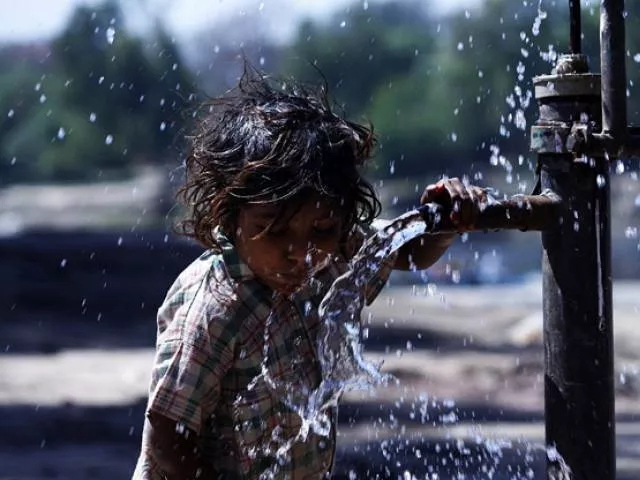 a girl drinking water from a hand pump on the eve of world water day photo online a girl drinking water from a hand pump on the eve of world water day photo online