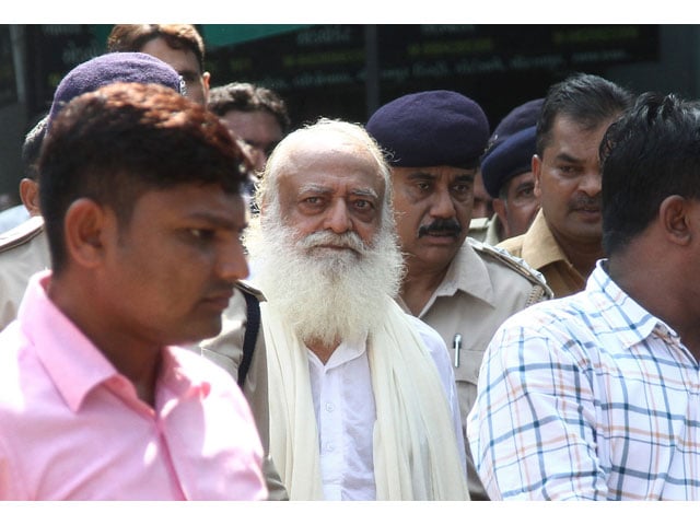 in this file photo taken on october 15 2013 indian spiritual guru asaram bapu c is escorted by state police as he leaves a local court in gandhinagar some 30 km from ahmedabad photo afp