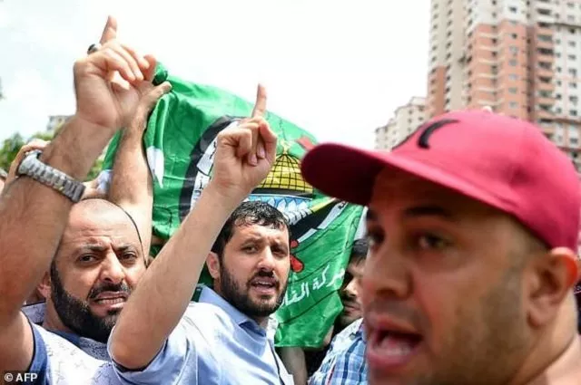 mourners shout as they carry the coffin of late palestinian professor fadi mohammad al batsh photo afp mourners shout as they carry the coffin of late palestinian professor fadi mohammad al batsh photo afp