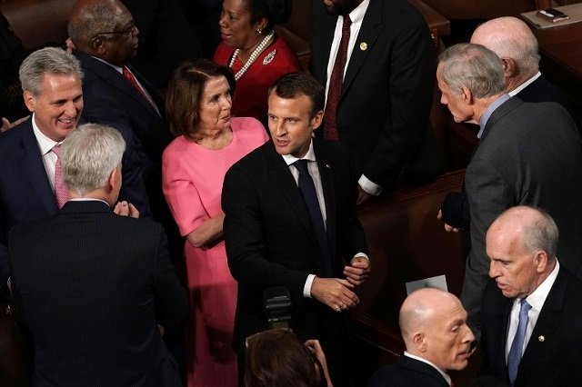 french president emmanuel macron is greeted by us lawmakers as he arrives at congress to deliver an address photo afp