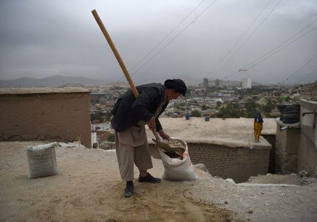 an afghan day laborer shovels soil into a sack as he works on a reconstruction site in kabul on august 14 2017 photo afp file