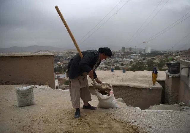 an afghan day laborer shovels soil into a sack as he works on a reconstruction site in kabul on august 14 2017 photo afp file an afghan day laborer shovels soil into a sack as he works on a reconstruction site in kabul on august 14 2017 photo afp file