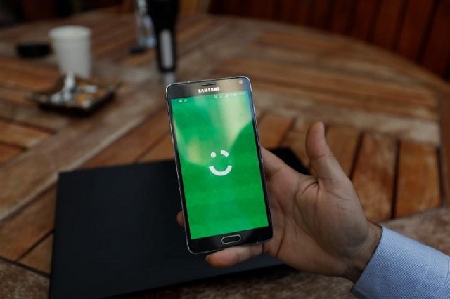 an employee shows the logo of ride hailing company careem on his mobile in his office in the west bank city of ramallah july 17 2017 picture taken july 17 2017 photo reuters