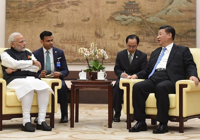 this handout photograph released by india 039 s ministry of external affairs on april 27 2018 shows india 039 s prime minister narendra modi l meeting with chinese president xi jinping in wuhan photo afp