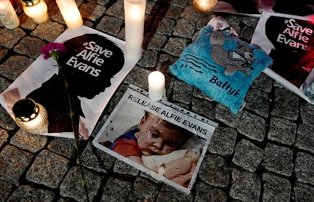 candles and placards are pictured during a protest in support of alfie evans in front of the british embassy building in warsaw poland april 26 2018 photo reuters