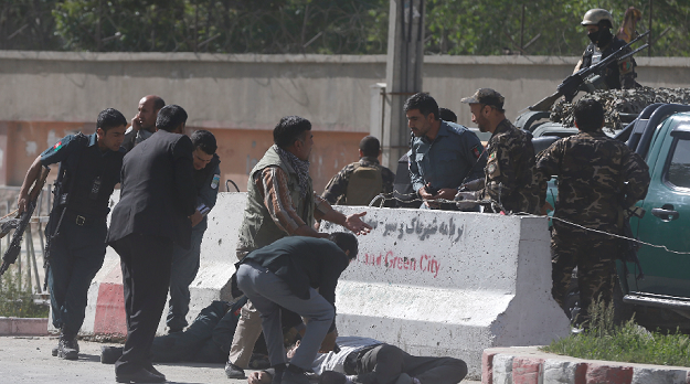 policemen help afghan journalists victims of a second blast photo reuters